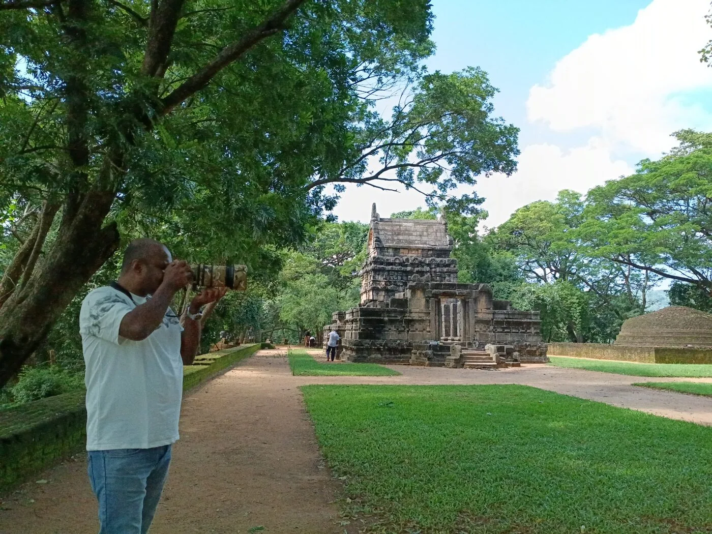 Chamal Suranga Fernando photographing birds at a Sri Lankan heritage site